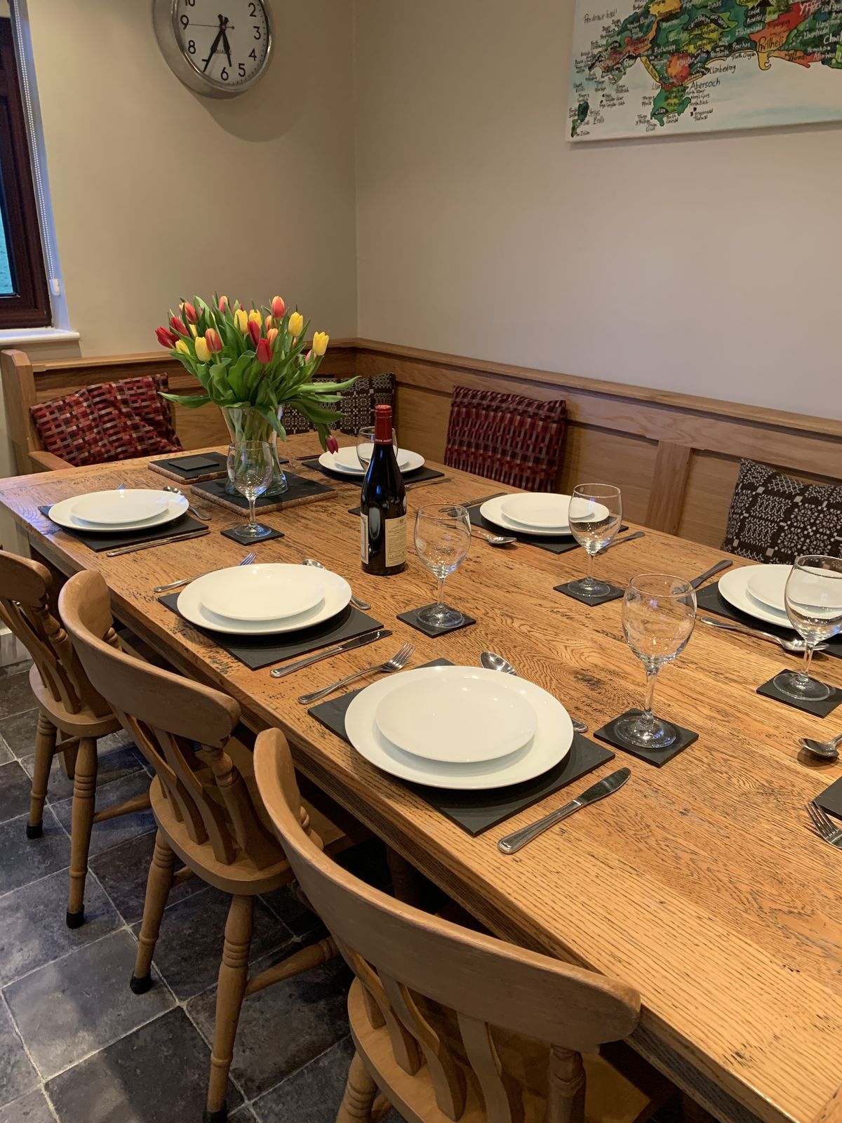 The kitchen-diner's oak table, set for dinner